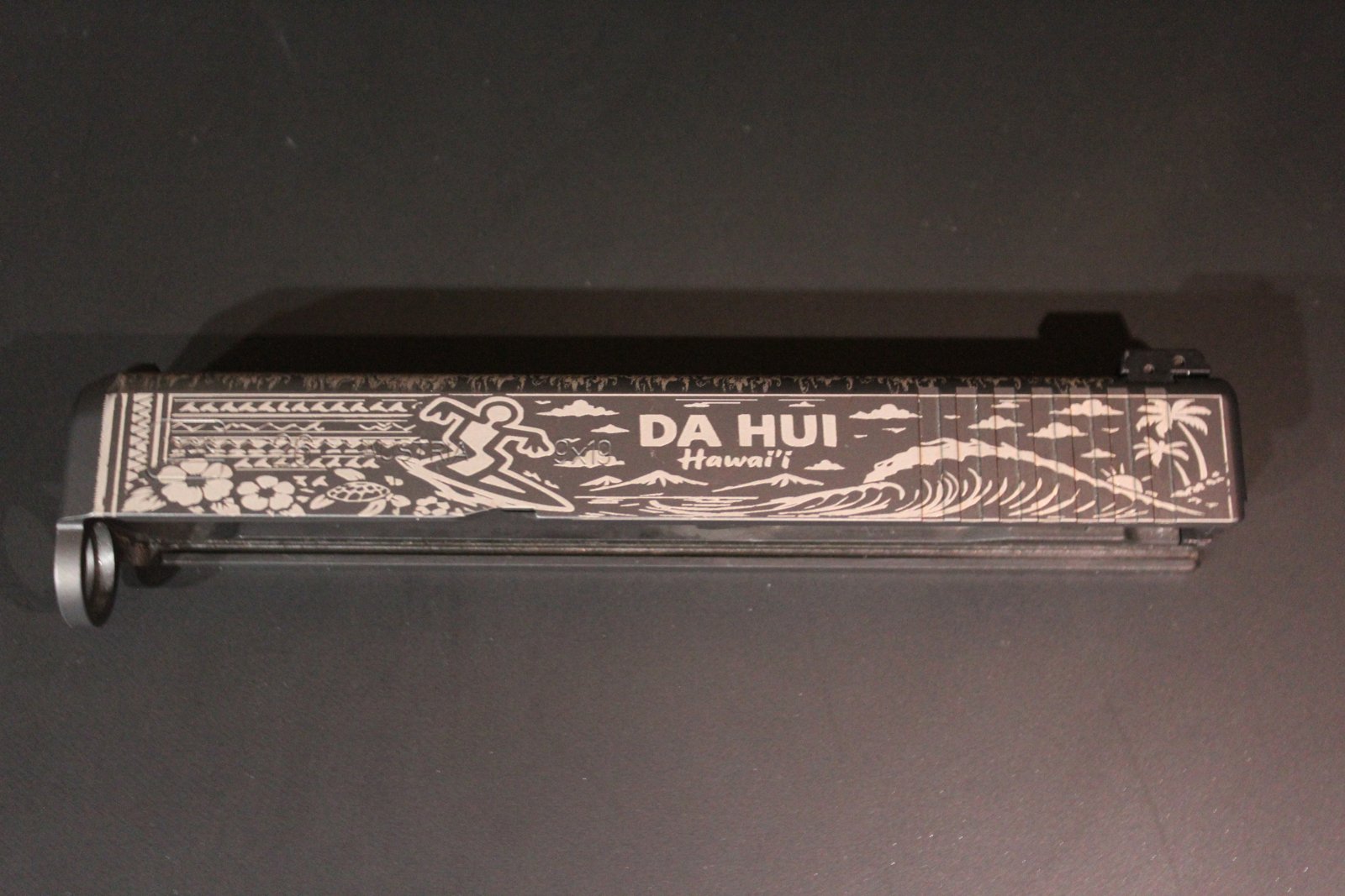 Da Hui Hawai'i design laser engraved on a Glock slide