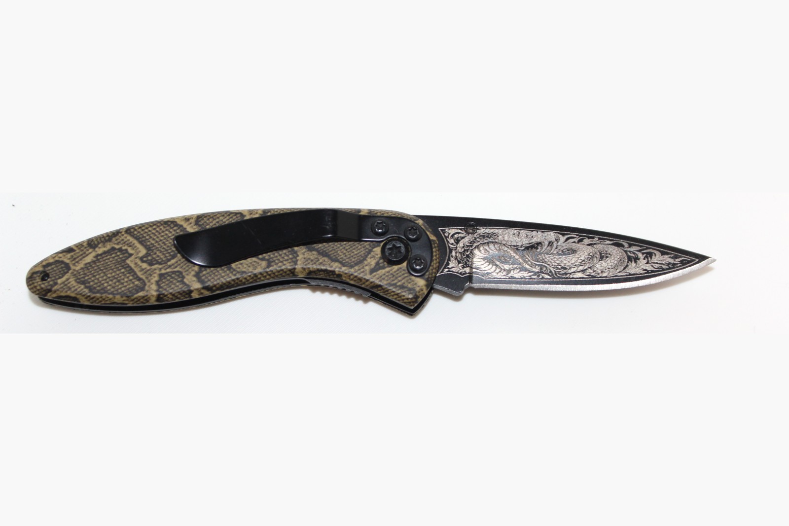 Serpent design laser engraved on a folding knife blade
