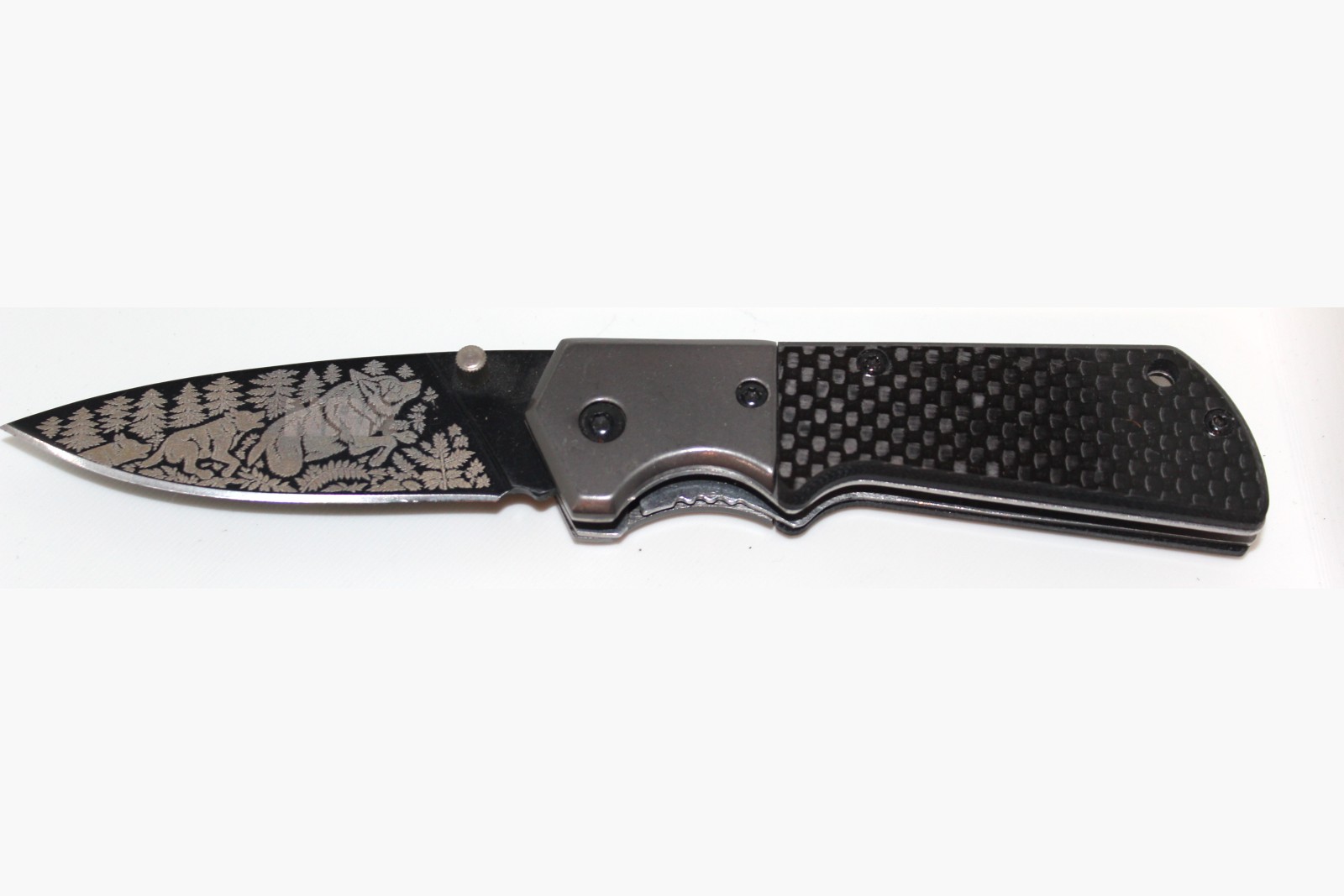 Wolf Pack design laser engraved on a folding knife blade